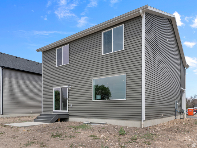 738 West 2840 South, Unit 6 Nibley, UT 84321 - Photo 4 of 23 Two-story exterior featuring horizontal siding, multiple windows, and a sliding glass door