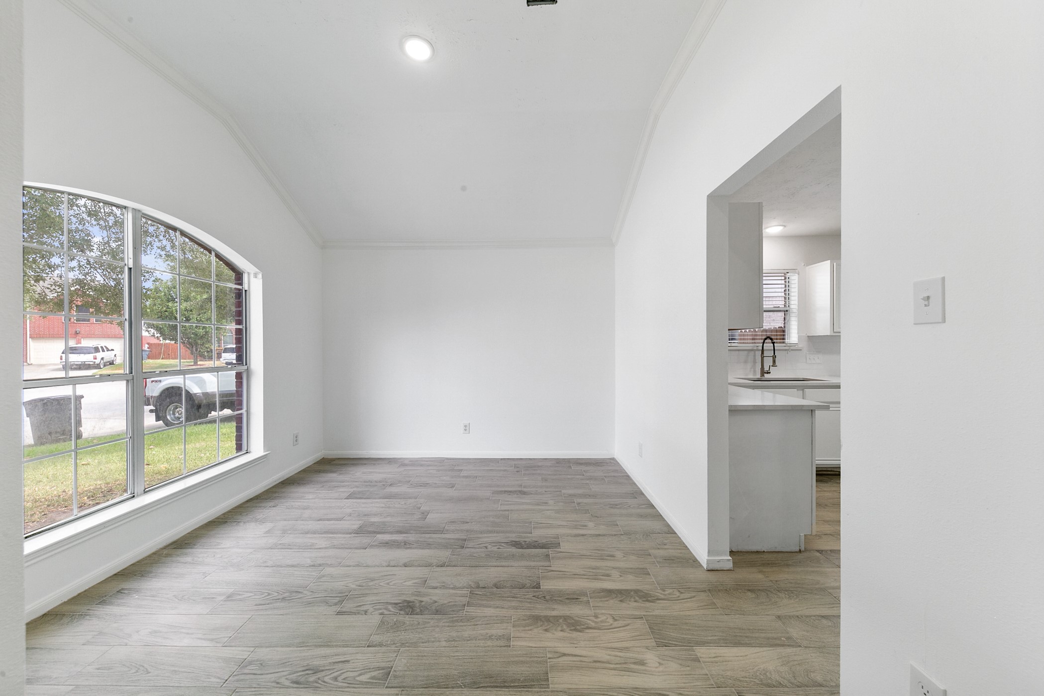 12014 Raven View Drive Houston, TX 77067 - Photo 3 of 29 This bright, open space features wood-style flooring, a large arched window providing plenty of natural light, and an adjoining kitchen with modern fixtures, perfect for family gatherings.