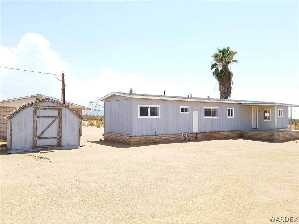 3645 Ligurta Road Golden Valley, AZ 86413 - Photo 11 of 17 Rear view of home and pump shed