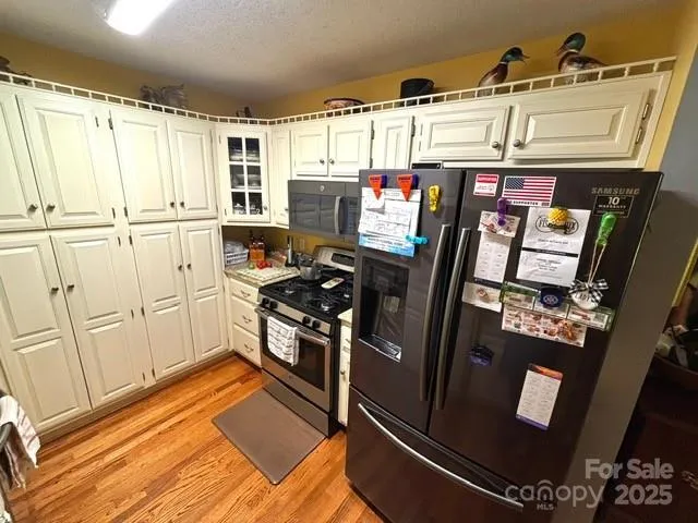 a kitchen with stainless steel appliances a refrigerator stove and sink