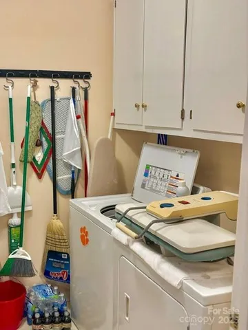 a bed sitting in a kitchen next to a window