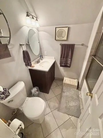 a bathroom with a sink mirror vanity and toilet
