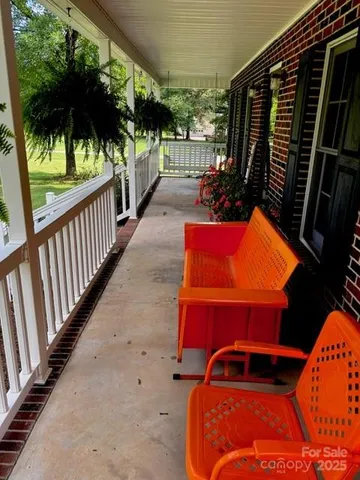 a view of balcony with wooden floor and outdoor seating