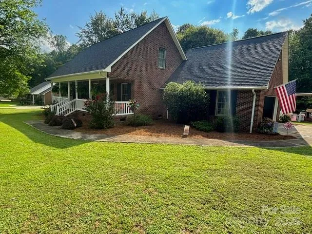 a view of a house with backyard sitting area and garden