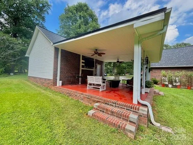 a view of a backyard with porch and furniture