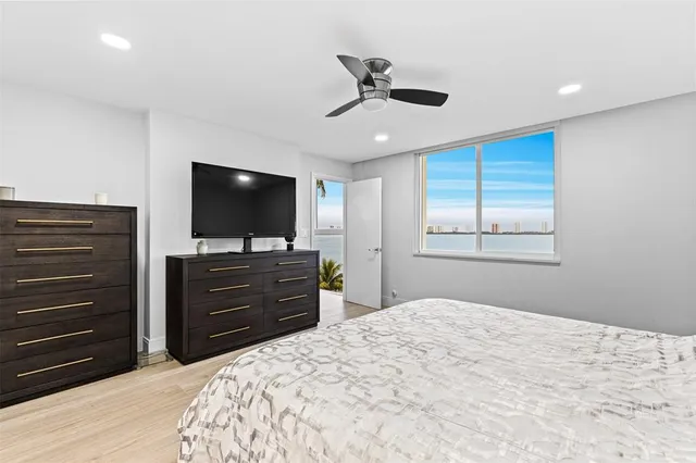 a bedroom with a bed and a flat screen television