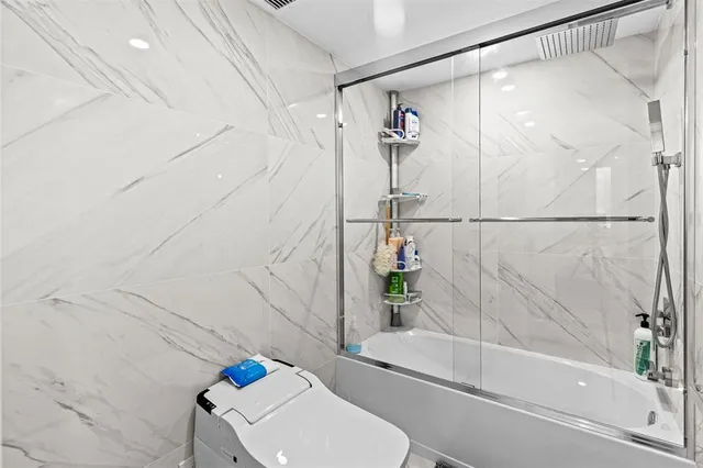 a spacious bathroom with a double vanity sink a mirror and a shower