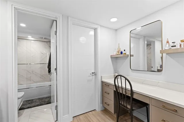 a spacious bedroom with a bed and a dresser