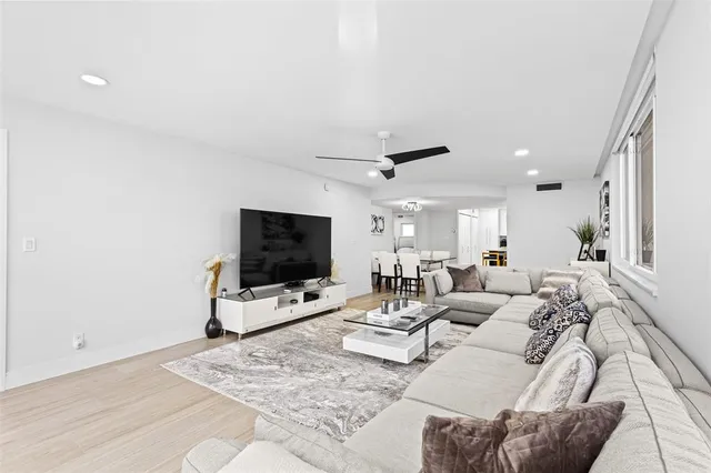 a kitchen with stainless steel appliances a stove a refrigerator and a dining table