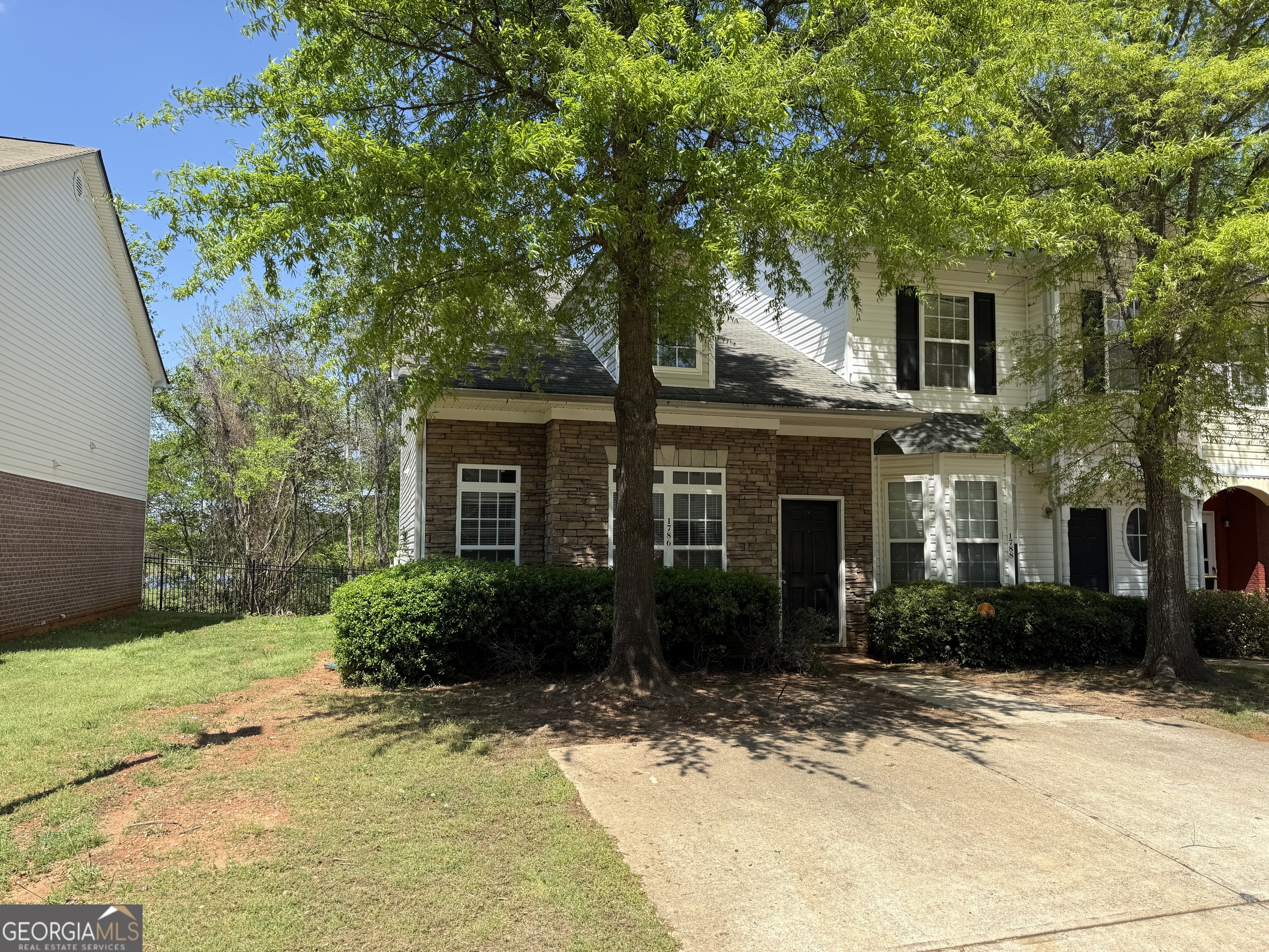 a front view of a house with garden