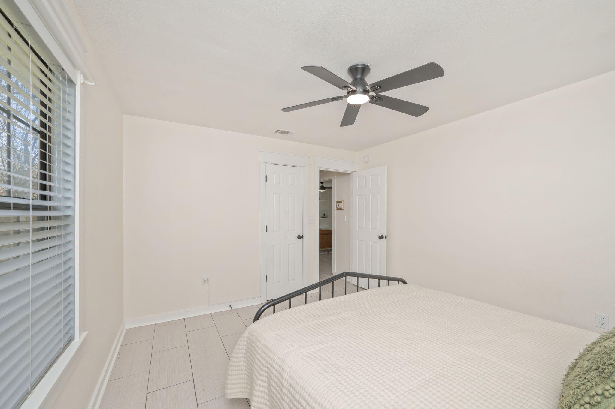 5816 Jack Stokes Road Baker, FL 32531 - Photo 11 of 16 a bedroom with a bed and a chandelier