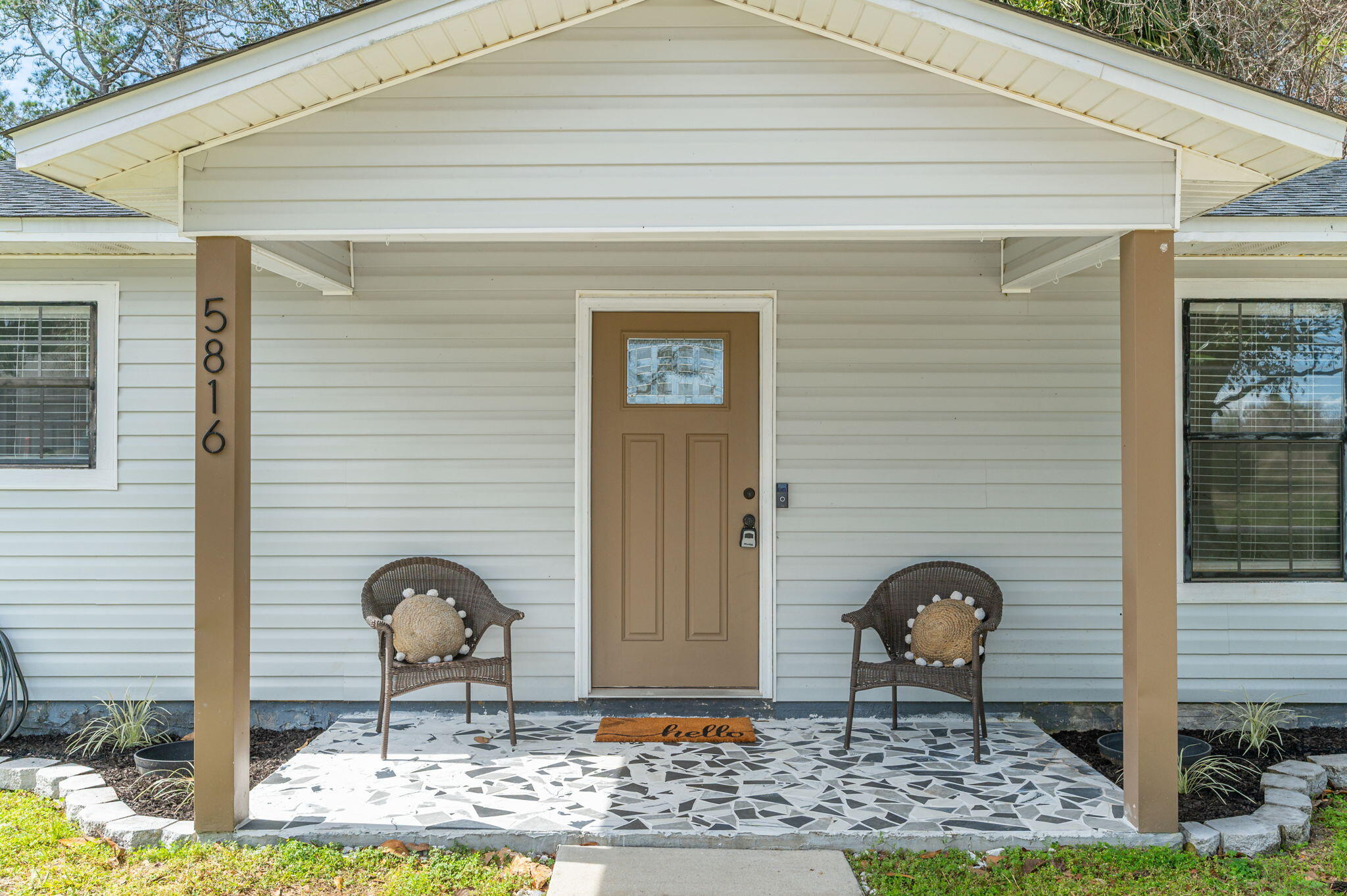 5816 Jack Stokes Road Baker, FL 32531 - Photo 2 of 16 a front view of a house with garden