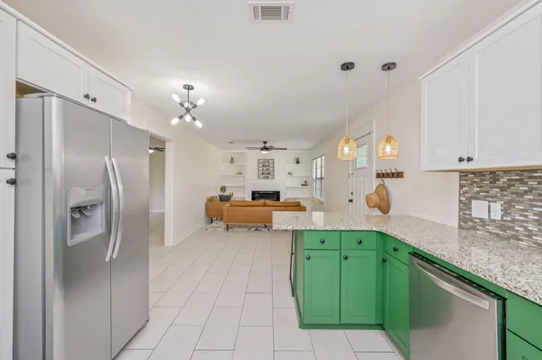 a kitchen with kitchen island a sink stainless steel appliances and cabinets