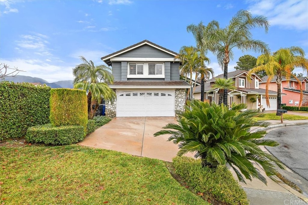 11000 Shaw Street Rancho Cucamonga, CA 91701 - Photo 1 of 1 a front view of a house with a garden