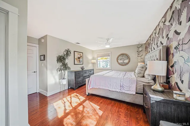 a spacious bedroom with a bed and a table in it