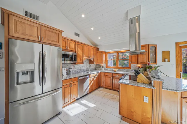 a kitchen with stainless steel appliances granite countertop a refrigerator and a sink