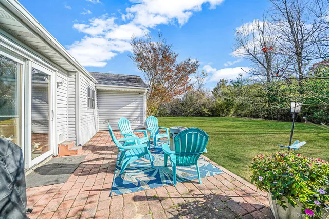 a view of a chair and tables in the backyard of the house