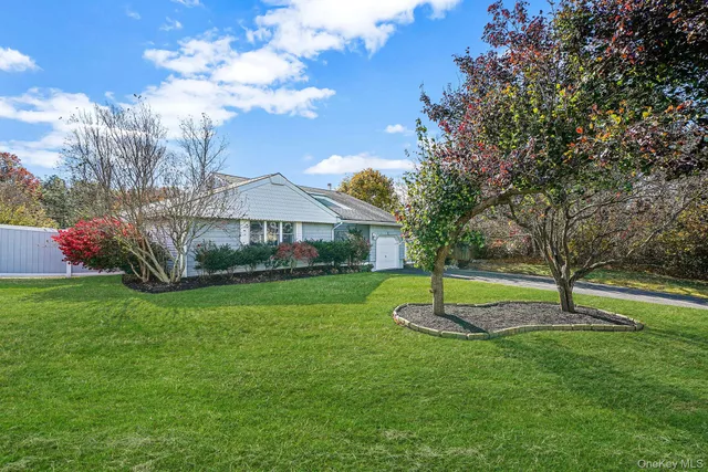 a house with green field in front of it