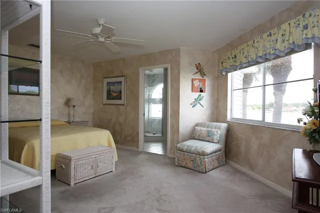 a spacious bedroom with a bed and a couch