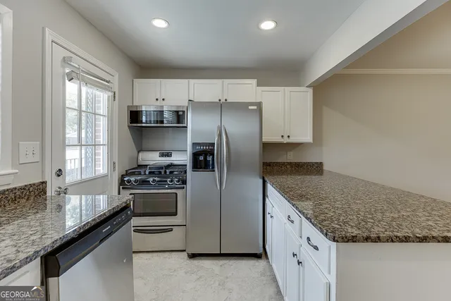 a kitchen with a sink stove and cabinets