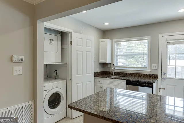an empty room with a window and a ceiling fan