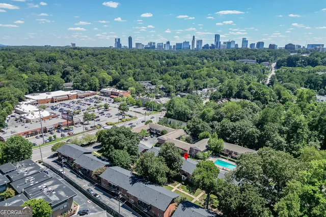 an aerial view of multiple houses with a street