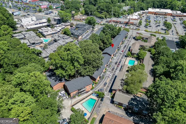 an aerial view of multiple houses with yard