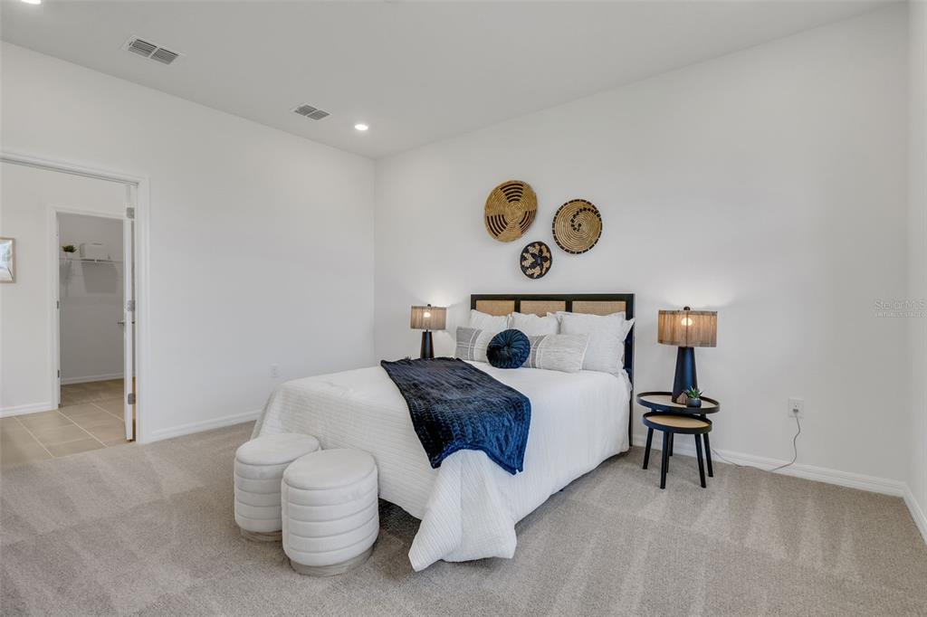 17024 Cottontail Circle Punta Gorda, FL 33982 - Photo 21 of 43 a bedroom with a bed and a table in it