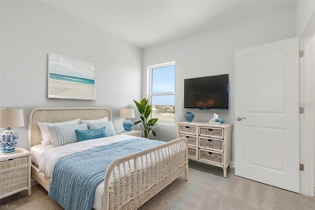 17024 Cottontail Circle Punta Gorda, FL 33982 - Photo 28 of 43 a bedroom with a bed and a flat screen tv