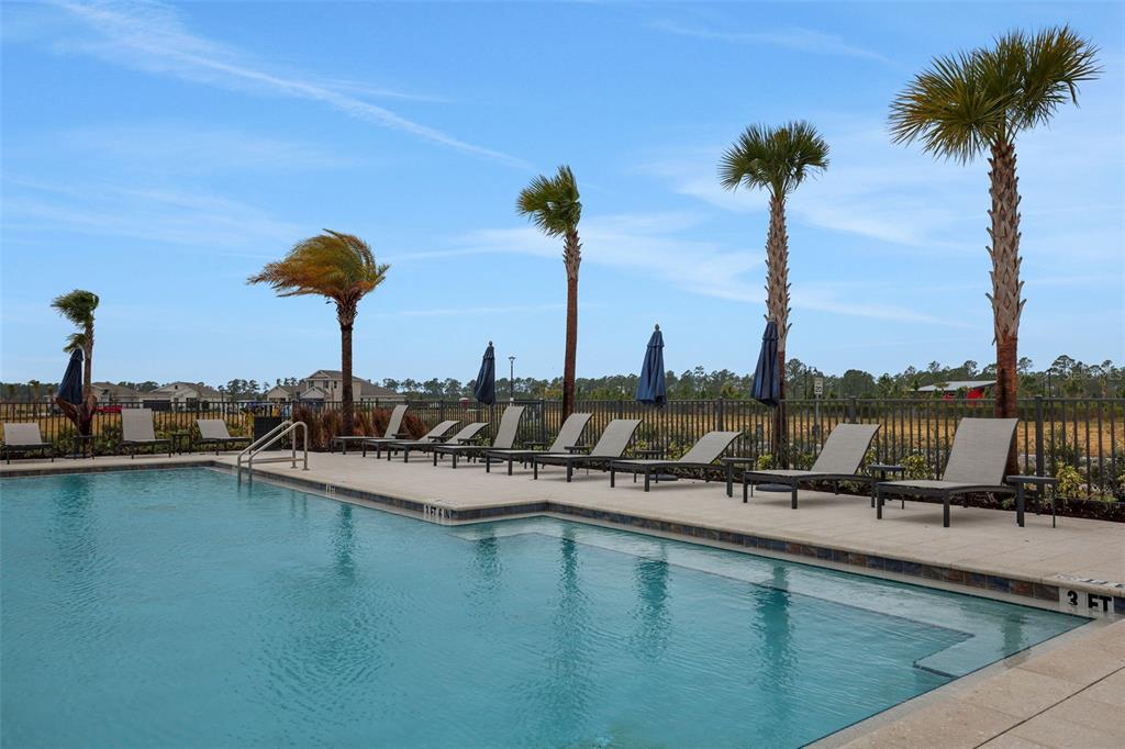 17024 Cottontail Circle Punta Gorda, FL 33982 - Photo 42 of 43 a view of a swimming pool with a table and chairs
