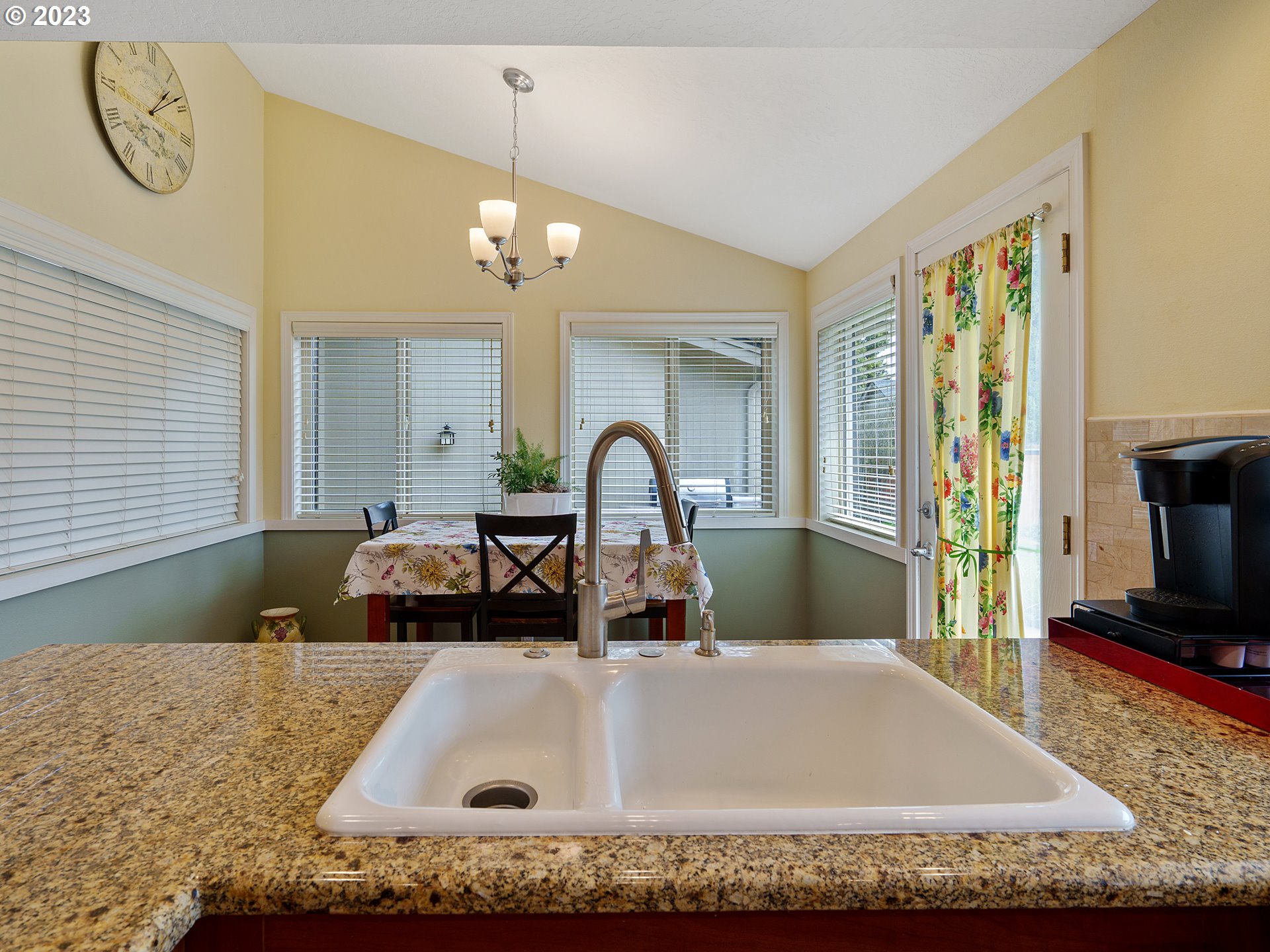 992 Spyglass Drive Eugene, OR 97401 - Photo 11 of 35 a kitchen with a sink a faucet and a dining table