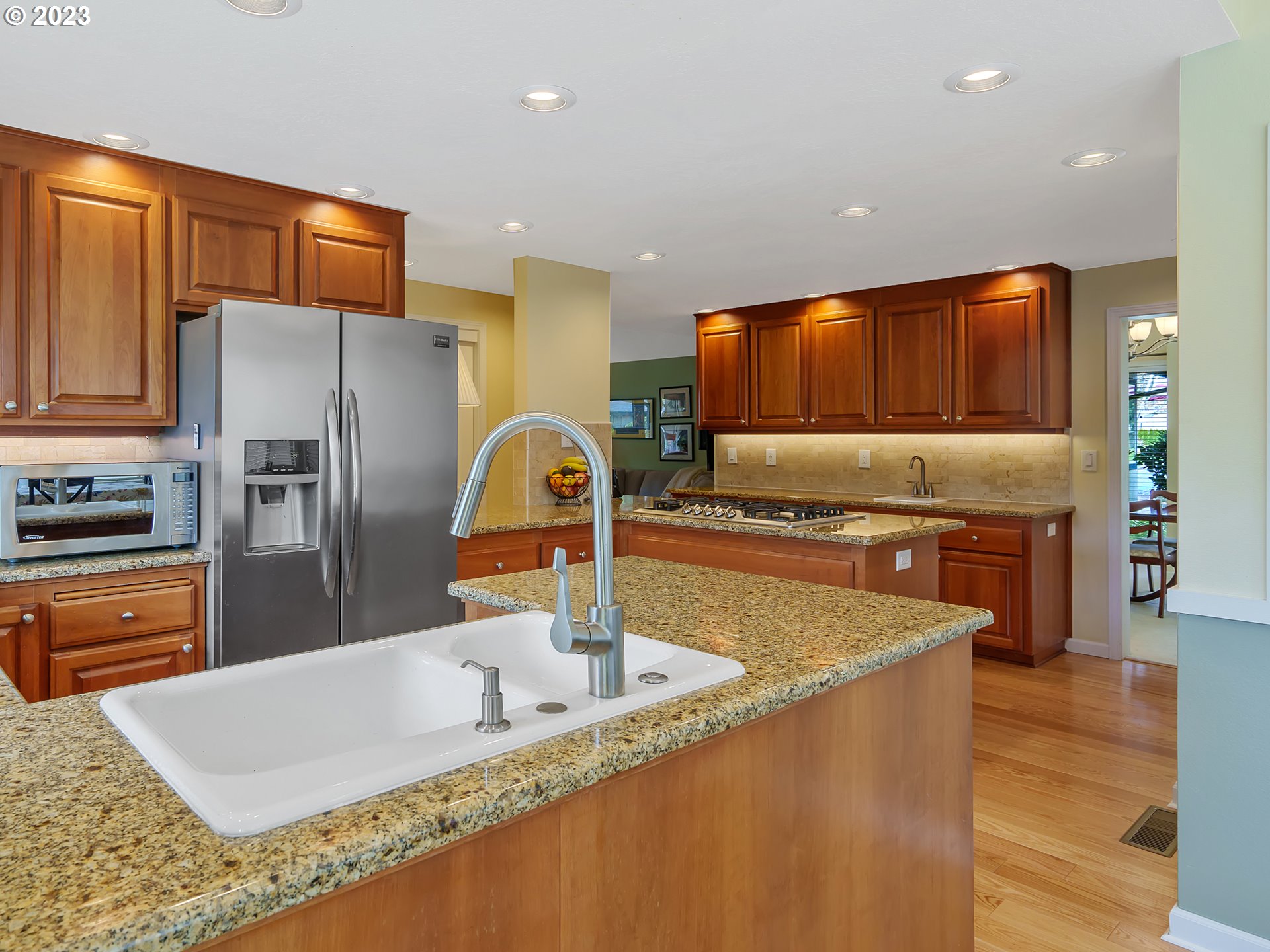 992 Spyglass Drive Eugene, OR 97401 - Photo 14 of 35 a kitchen with stainless steel appliances granite countertop a sink a stove and a refrigerator