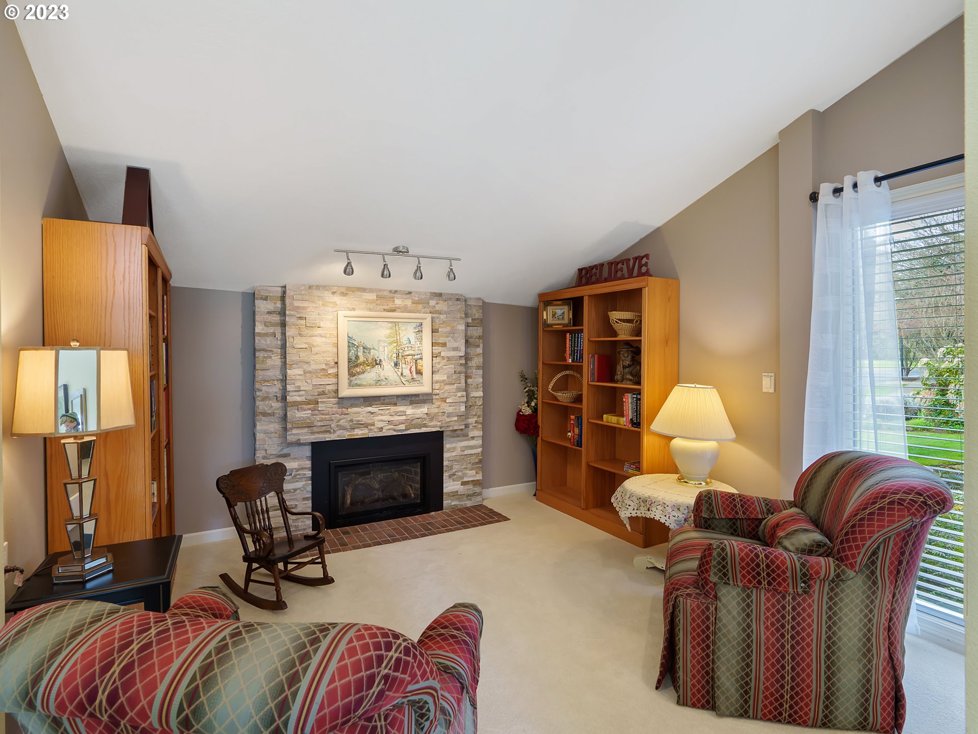 992 Spyglass Drive Eugene, OR 97401 - Photo 18 of 35 a living room with furniture a fireplace and a large window