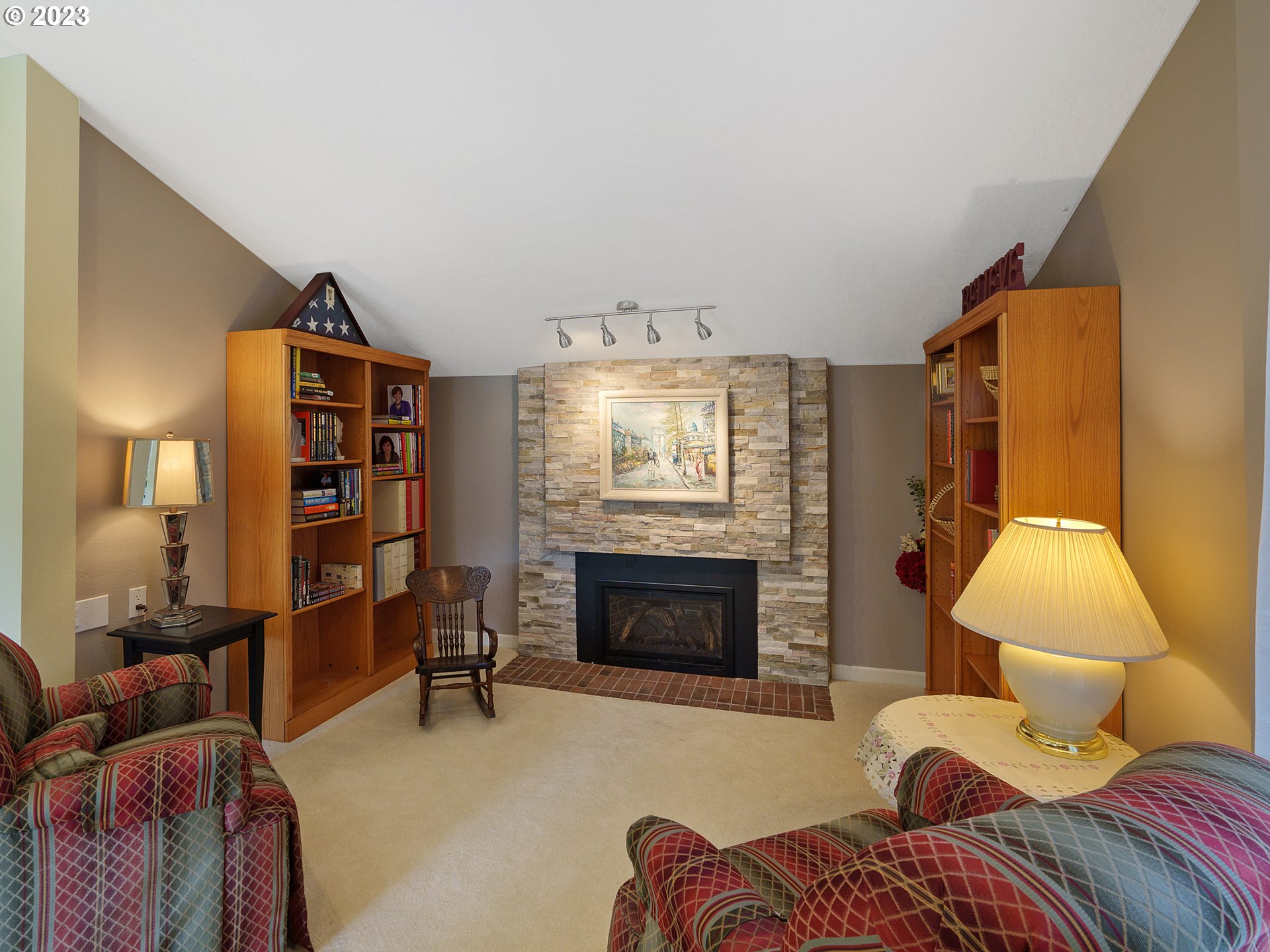 992 Spyglass Drive Eugene, OR 97401 - Photo 19 of 35 a living room with furniture a fireplace and a flat screen tv