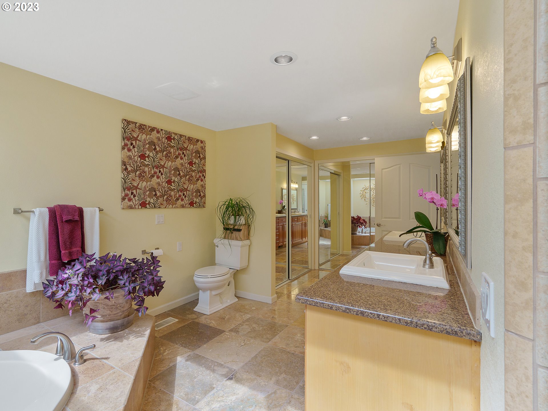 992 Spyglass Drive Eugene, OR 97401 - Photo 24 of 35 a bathroom with a granite countertop sink a toilet and a mirror
