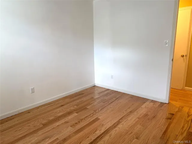 a view of an empty room and wooden floor