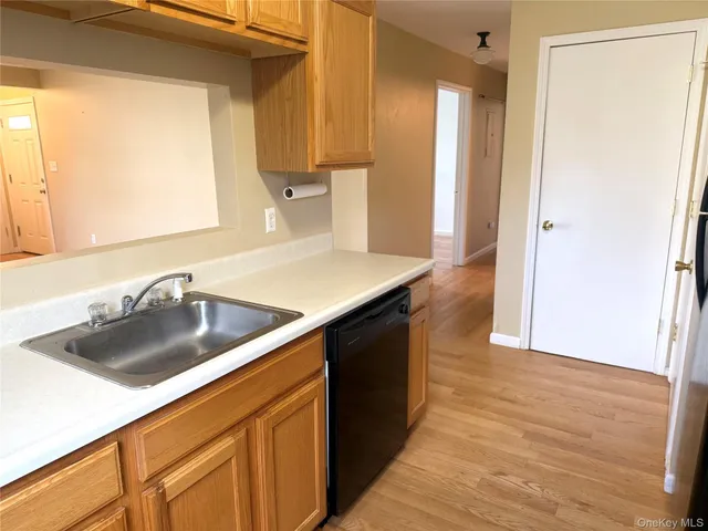a kitchen with a sink and a refrigerator