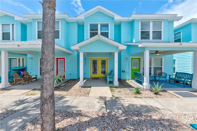 a front view of a building with glass windows and table