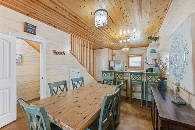a kitchen with stainless steel appliances granite countertop white cabinets granite counter tops and a window