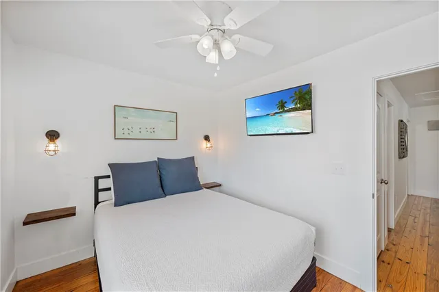 a view of a patio with a dining table and chairs under an umbrella with a barbeque