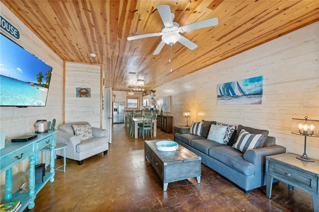 a view of a dining room with furniture and a chandelier