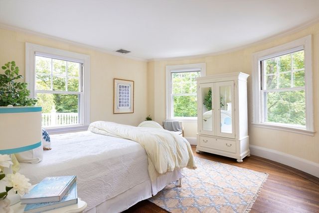 a bedroom with a bed and large window