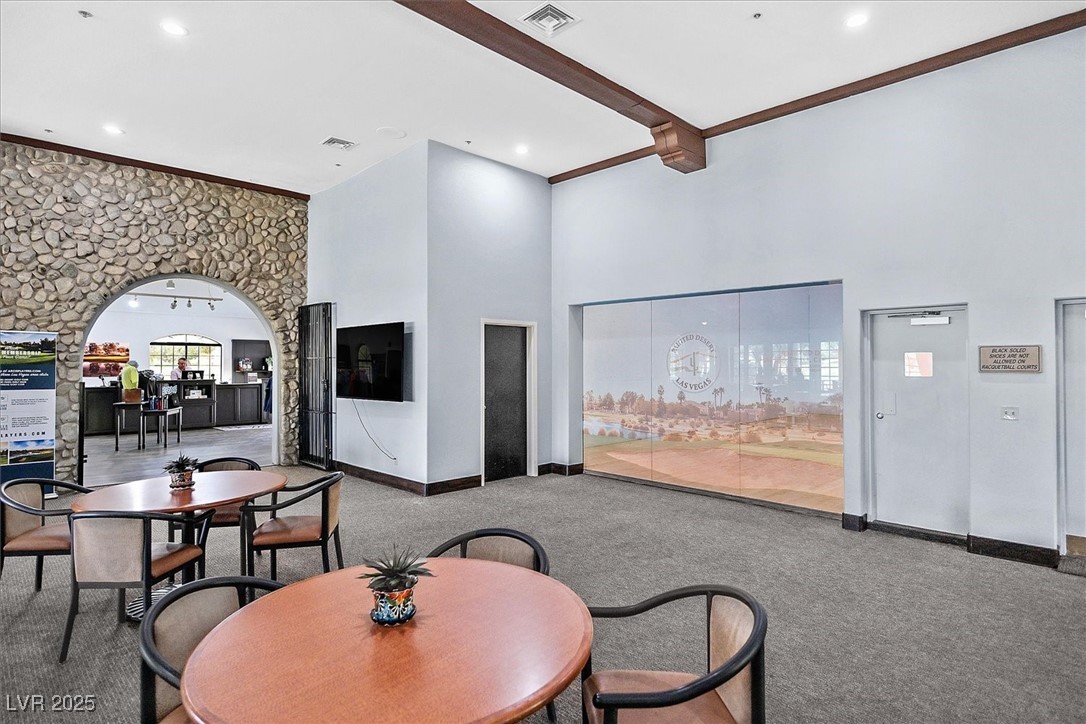 5421 Painted Mirage Road Las Vegas, NV 89149 - Photo 28 of 35 Dining area with arched walkways, carpet, visible vents, a high ceiling, and beamed ceiling