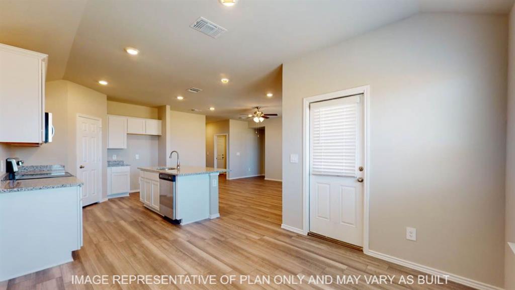 10325 Altair Drive Waco, TX 76708 - Photo 5 of 15 a kitchen with a refrigerator and a sink