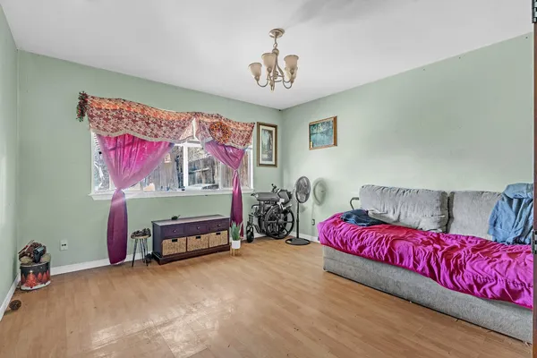 a bedroom with a bed and a chandelier