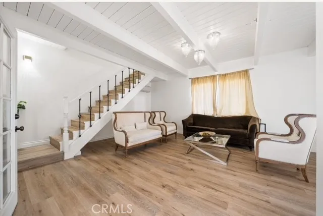 a living room with furniture and a ceiling fan