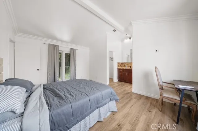 a spacious bedroom with a bed and a desk