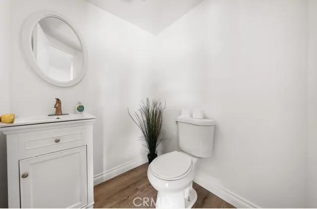 a bathroom with a toilet a sink and a mirror