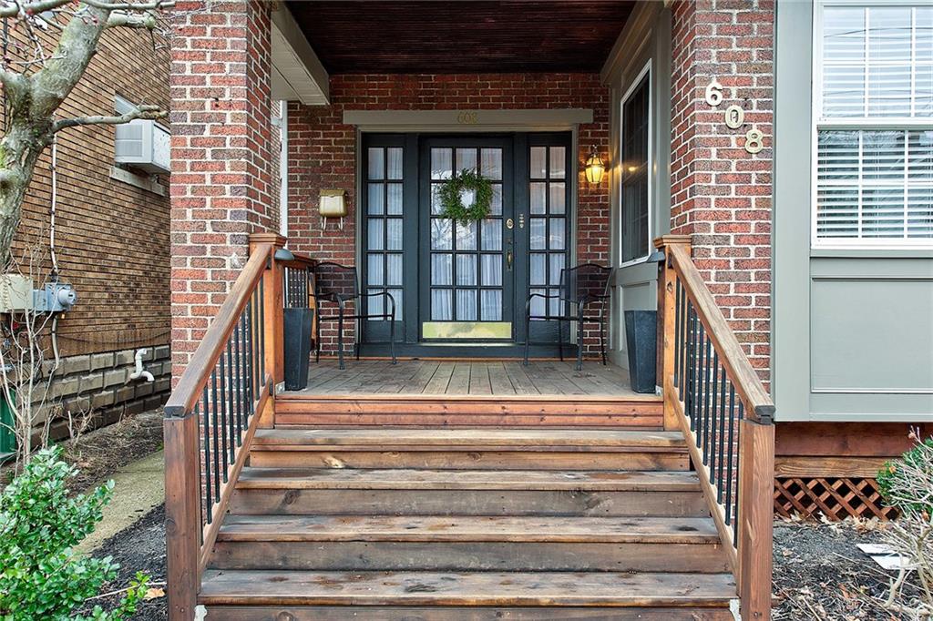 This front porch with glass-paneled door welcomes visitors.