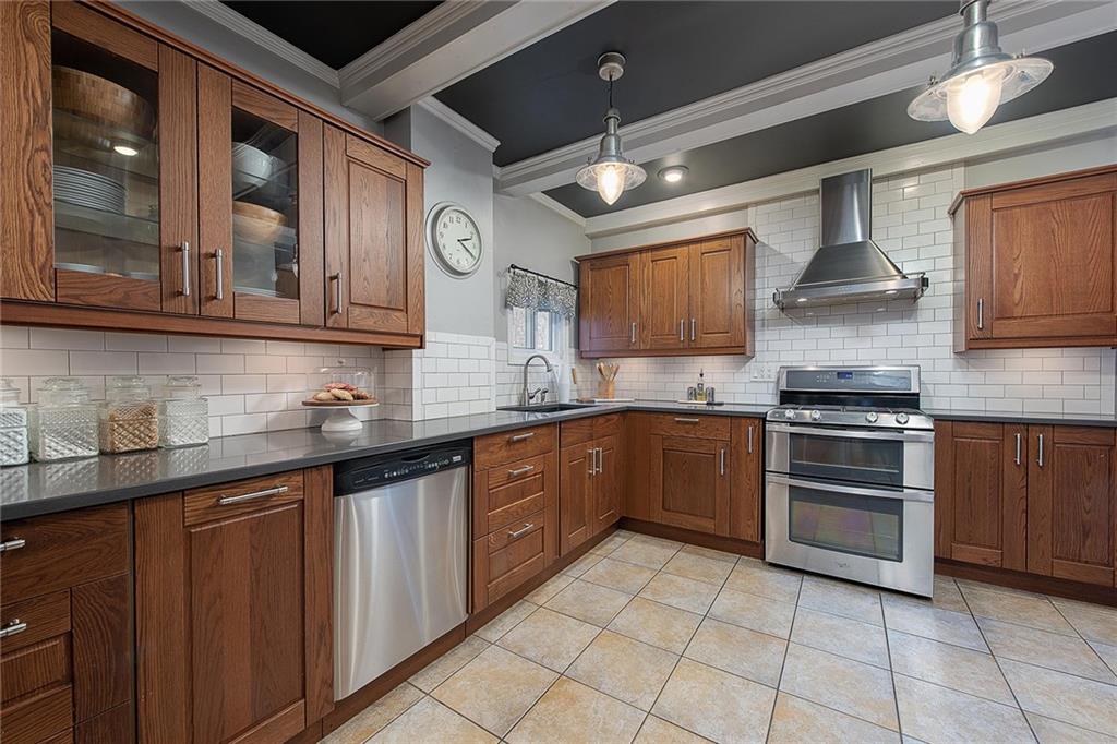 608 Blackburn Road Sewickley, PA 15143 - Photo 11 of 24 A chefs kitchen with stainless appliances such as this gas double-oven range and hood.